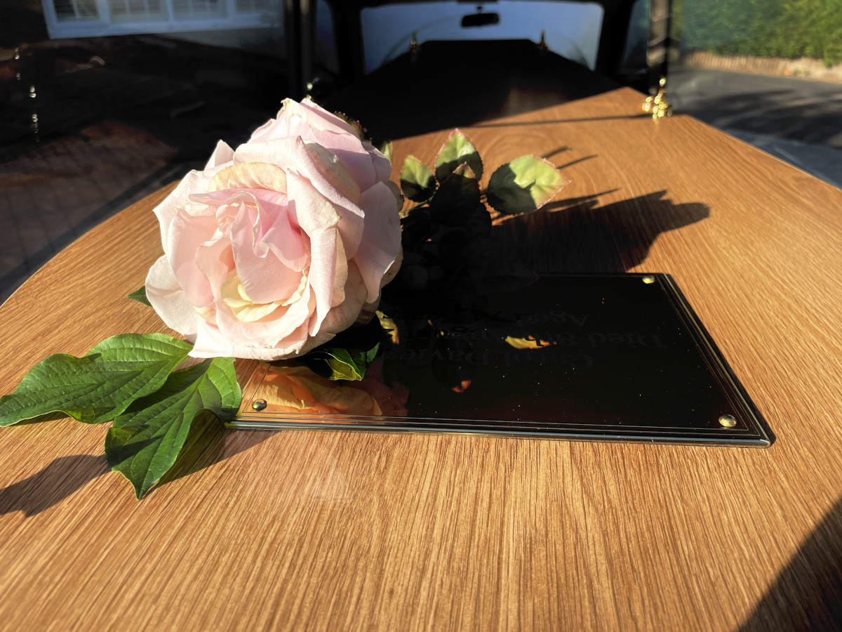 Personal Funeral - image with rose on coffin